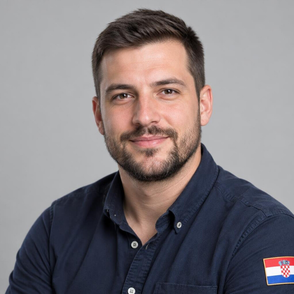 Portrait of a bearded man in a casual shirt smiling